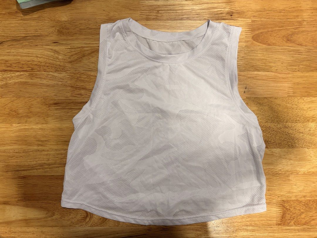 White Athletic Tank Top with Camo Pattern (Category: Sleeveless) located in Quezon City. Submitted by xiiaze (Listing ID 1461676134, Image 1). Description: - Lightweight white tank top - Subtle tonal camouflage pattern all over - Sleeveless design, ideal for workouts or casual wear - Breathable material for comfort.