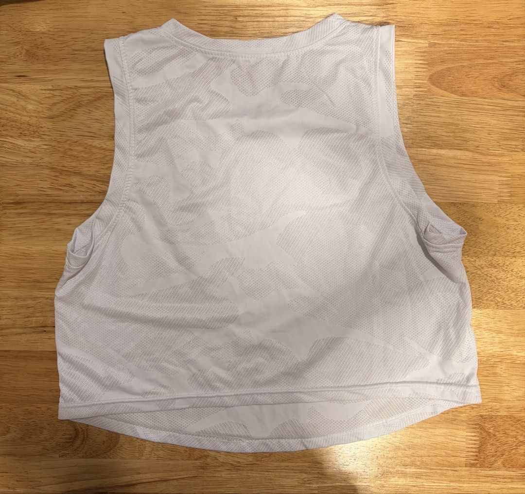 White Athletic Tank Top with Camo Pattern (Category: Sleeveless) located in Quezon City. Submitted by xiiaze (Listing ID 1461676134, Image 2). Description: - Lightweight white tank top - Subtle tonal camouflage pattern all over - Sleeveless design, ideal for workouts or casual wear - Breathable material for comfort.