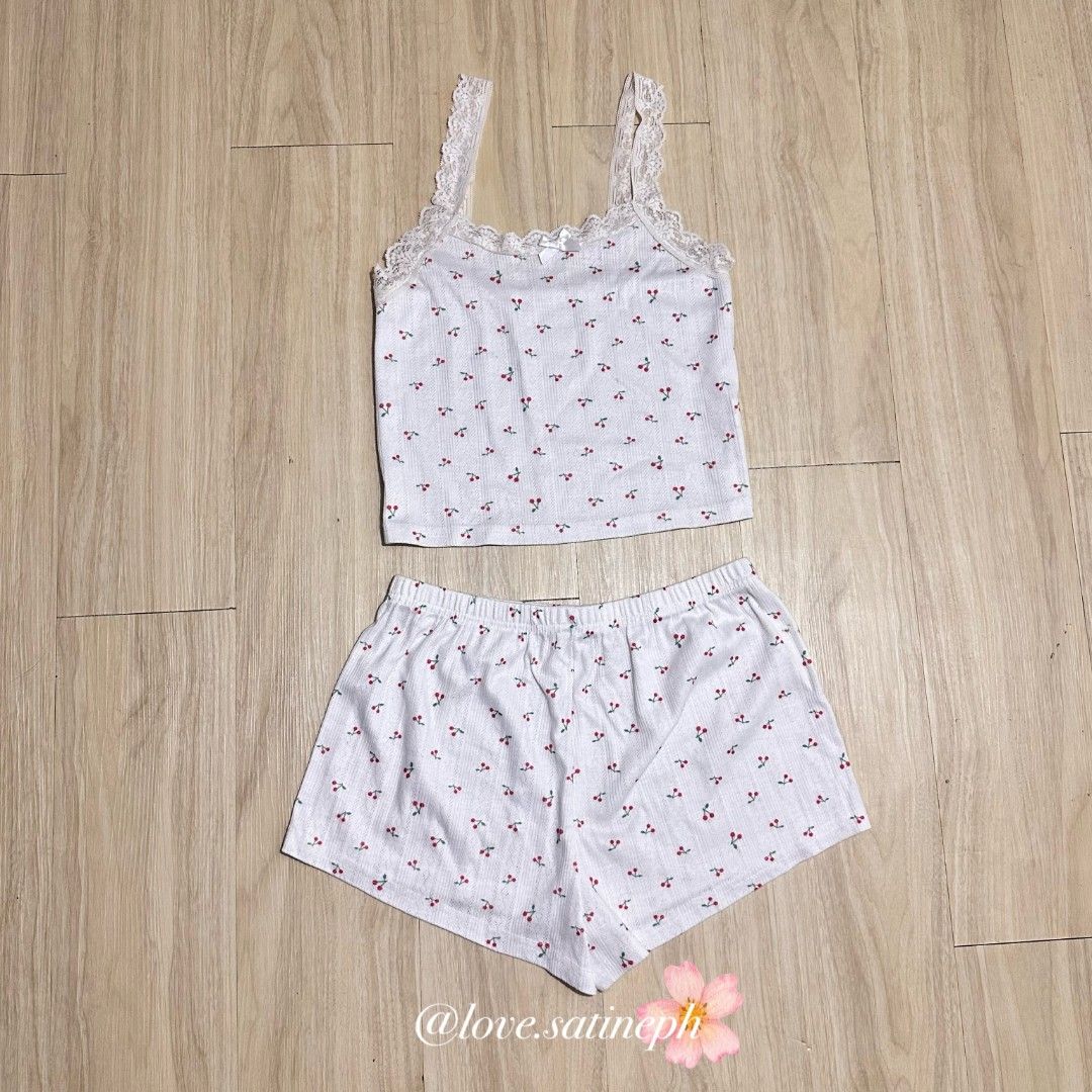 White Cherry Print Pajama Set with Lace Trim (Category: Undergarments & Loungewear) located in Manila. Submitted by love.satineph (Listing ID 1461605719, Image 1). Description: - Adorable white pajama set with a fun cherry print. - Features a ribbed texture on the camisole. - Delicate lace trim adds a feminine touch to the camisole. - Comfortable elastic waistband on the shorts. - Ideal for relaxing at home or a good night's sleep. - Perfect for 
