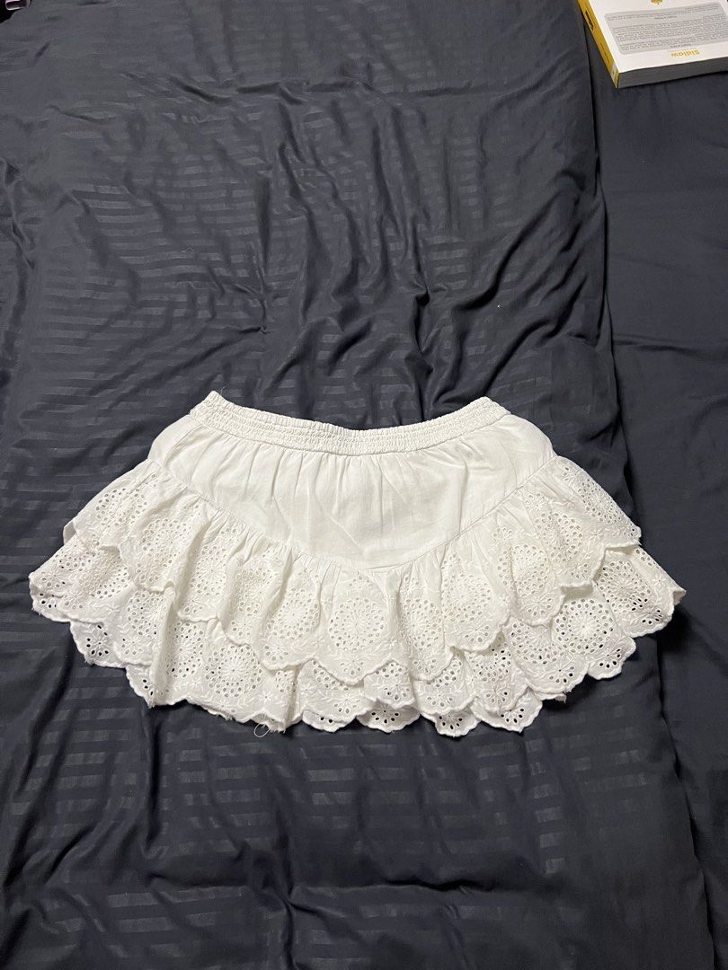 White Eyelet Tiered Mini Skirt (Category: Skirts) located in Paranaque City. Submitted by dubaichocolei (Listing ID 1461716861, Image 1). Description: - White tiered mini skirt - Eyelet details - Comfortable elastic waistband - Breezy and cute style - Ideal for summer or beach vibes - Versatile for pairing with different tops.