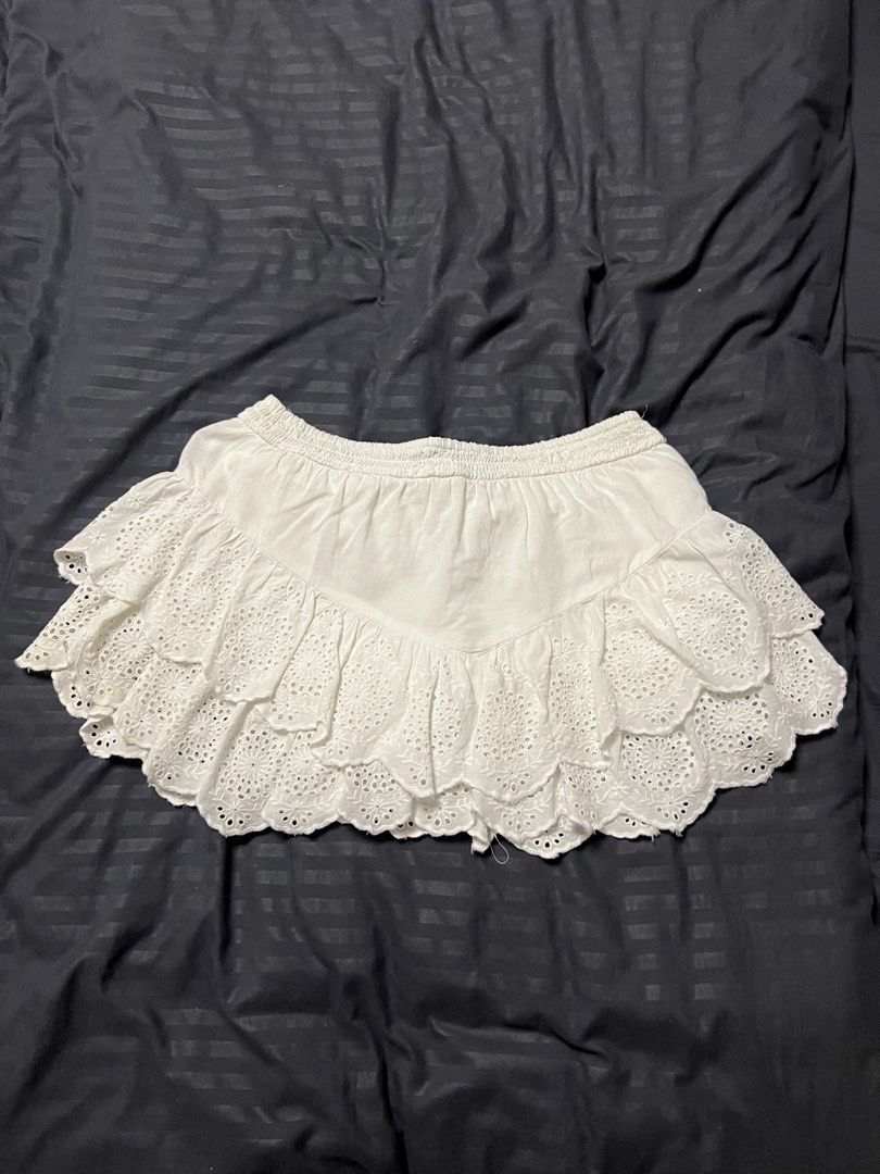 White Eyelet Tiered Mini Skirt (Category: Skirts) located in Paranaque City. Submitted by dubaichocolei (Listing ID 1461716861, Image 2). Description: - White tiered mini skirt - Eyelet details - Comfortable elastic waistband - Breezy and cute style - Ideal for summer or beach vibes - Versatile for pairing with different tops.