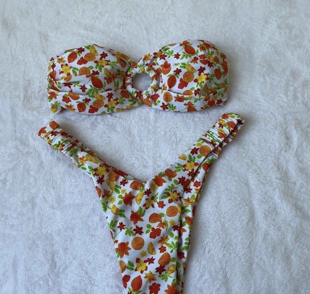 White Floral Fruit Print Bikini Set (Category: Bikinis & Swimsuits) located in Kawit. Submitted by wevibevintage (Listing ID 1461589836, Image 1). Description: - Adorable bikini set with a white base. - Features a fun fruit and floral print. - Bandeau top with a cute center knot detail. - High-cut thong style bottoms. - Ideal for beach days, pool parties, and vacations..