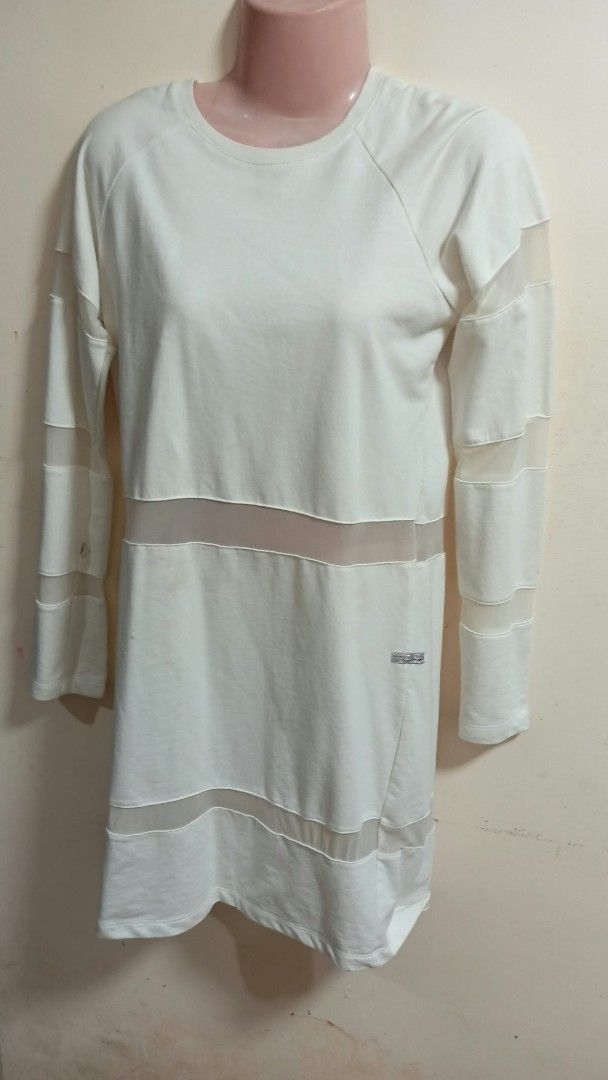 White Long Sleeve Mesh Panel Tunic Dress (Category: Dresses) located in San Jose del Monte. Submitted by pinkpenguin.2005ya (Listing ID 1461700151, Image 1). Description: - White long sleeve tunic dress - Sheer mesh panels on sleeves, chest, and hem - Raglan sleeves for a modern fit - Asymmetrical hemline for a stylish look - Small logo tag on the side - Versatile: great for layering or wearing on its own.
