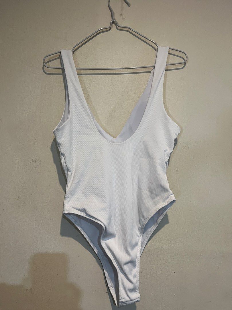 White Ribbed V-Neck One Piece Swimsuit (Category: Bikinis & Swimsuits) located in Caloocan City. Submitted by towtsph (Listing ID 1461595988, Image 2). Description: - Classic white one-piece swimsuit - Ribbed texture for a chic look - Flattering deep V-neckline - High-cut leg design - Perfect for beach or pool days - Comfortable and simple design.