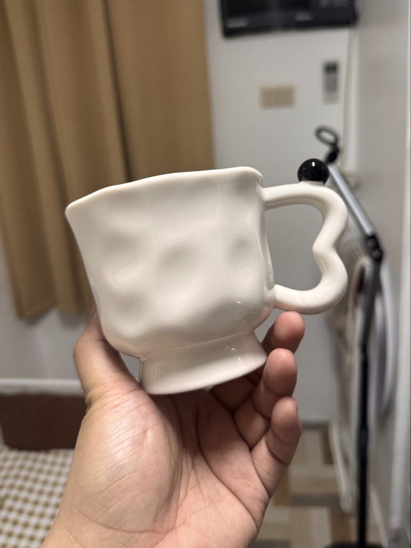 Ceramic White Textured Mug with Black Accent Handle (Category: Coffee & Tea Tableware) located in Calamba. Submitted by keemi_ (Listing ID 1461736215, Image 2). Description: - ₱200 - Unique textured white mug - Ceramic - Cute black ball accent on the handle - Ideal for coffee or tea - Standard drink size.