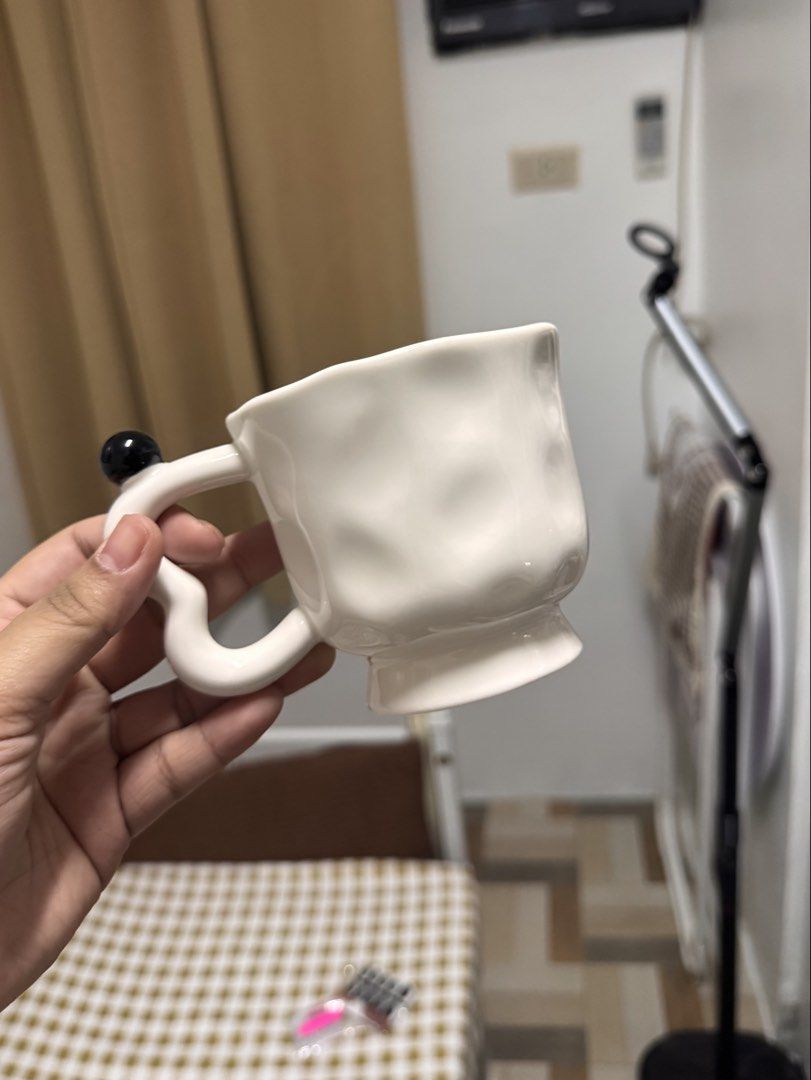 Ceramic White Textured Mug with Black Accent Handle (Category: Coffee & Tea Tableware) located in Calamba. Submitted by keemi_ (Listing ID 1461736215, Image 1). Description: - ₱200 - Unique textured white mug - Ceramic - Cute black ball accent on the handle - Ideal for coffee or tea - Standard drink size.