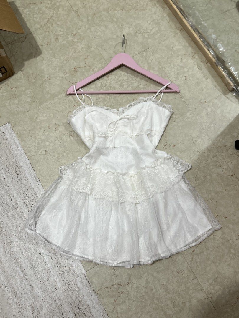 WITWIT White Lace Ruffle Mini Dress (Category: Dresses) located in Batangas. Submitted by nommi26 (Listing ID 1461741278, Image 1). Description: Large on tag fits M to L - Cute white mini dress from WITWIT - Features delicate lace detailing and charming ruffles - Adjustable spaghetti straps for a perfect fit - Flattering tie-front bodice - Ideal for parties or special occasions - Made in Vietnam - Please check photos for more details.