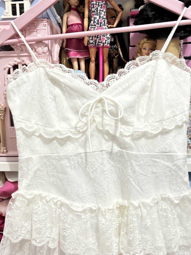 WITWIT White Lace Ruffle Mini Dress (Category: Dresses) located in Batangas. Submitted by nommi26 (Listing ID 1461741278, Image 3). Description: Large on tag fits M to L - Cute white mini dress from WITWIT - Features delicate lace detailing and charming ruffles - Adjustable spaghetti straps for a perfect fit - Flattering tie-front bodice - Ideal for parties or special occasions - Made in Vietnam - Please check photos for more details.