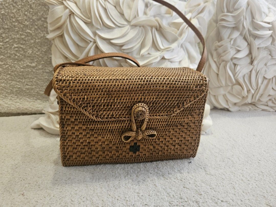 Woven Rattan Bag with Leather Strap and Batik Lining (Category: Shoulder Bags) located in Pasig City. Submitted by momshiem (Listing ID 1461594985, Image 1). Description: - Cute woven rattan bag - Rectangular shape with flap closure - Features braided detail and a small bow - Beautiful batik fabric lining (floral & bird motifs) - Comes with a brown leather strap - Ideal for beach days or casual outings - Bought in Bali Sf - c/o buyer .