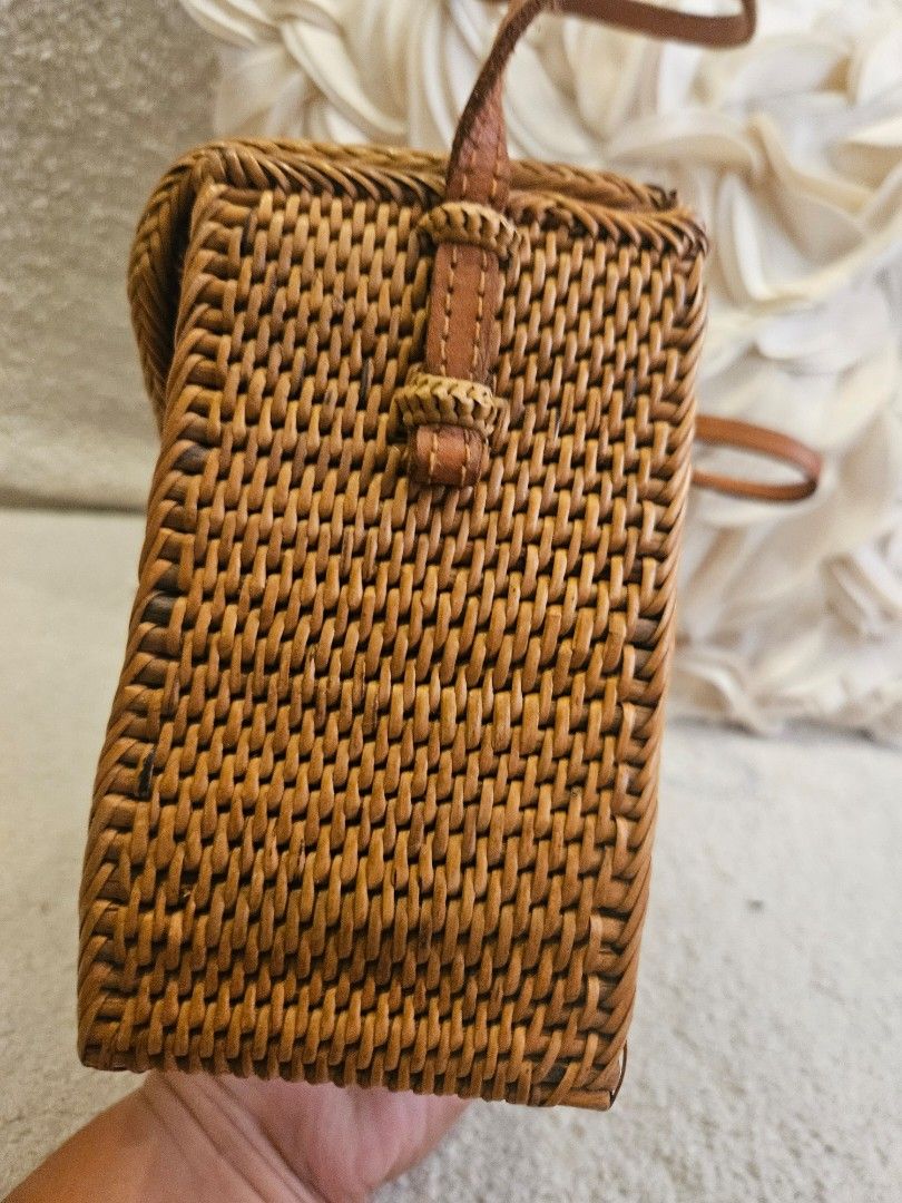 Woven Rattan Bag with Leather Strap and Batik Lining (Category: Shoulder Bags) located in Pasig City. Submitted by momshiem (Listing ID 1461594985, Image 2). Description: - Cute woven rattan bag - Rectangular shape with flap closure - Features braided detail and a small bow - Beautiful batik fabric lining (floral & bird motifs) - Comes with a brown leather strap - Ideal for beach days or casual outings - Bought in Bali Sf - c/o buyer .