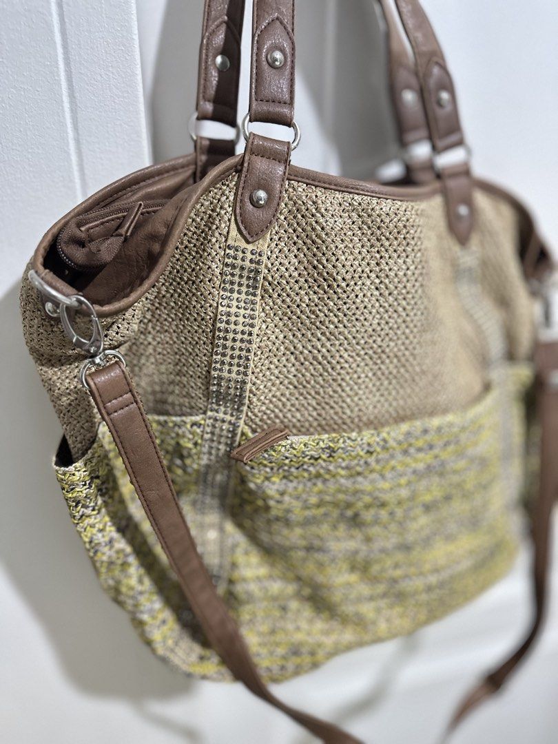 Woven Tote Bag with Leather Straps (Category: Tote Bags) located in Mandaluyong City. Submitted by TheWeekendProject (Listing ID 1461516927, Image 3). Description: - Cute woven tote bag - Brown leather straps - Textured pattern with yellow and brown accents - Zipper closure at the top - Detachable shoulder strap included - Spacious interior for essentials - Ideal for everyday use or beach trips - Dimension: 18” x 13 “ x 4”.