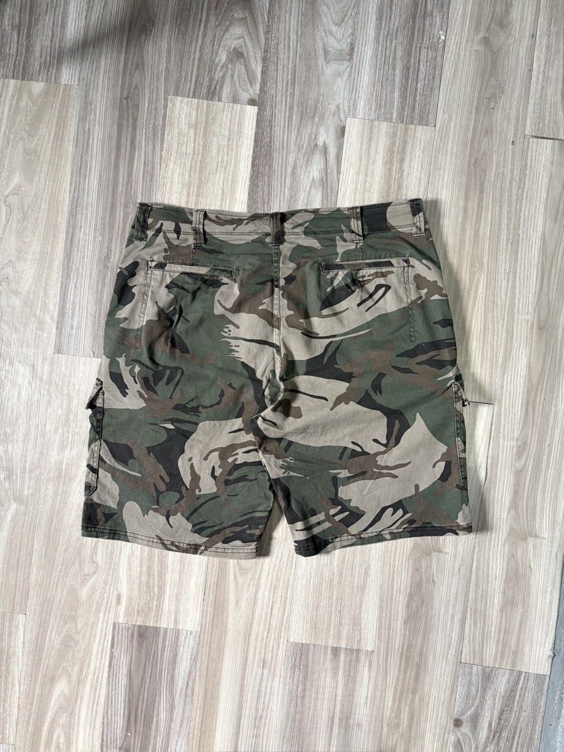 Wrangler Camo Cargo Shorts Size 38 (Category: Shorts) located in Rizal. Submitted by thriftdrip.402 (Listing ID 1461703582, Image 2). Description: - Brand: Wrangler - Type: Camo Cargo Shorts - Size: 38 Waist - Design: Classic camouflage pattern - Features: Multiple pockets for ample storage - Closure: Button and zip fly - Ideal for: Casual wear, outdoor activities - Origin: Made in Bangladesh.
