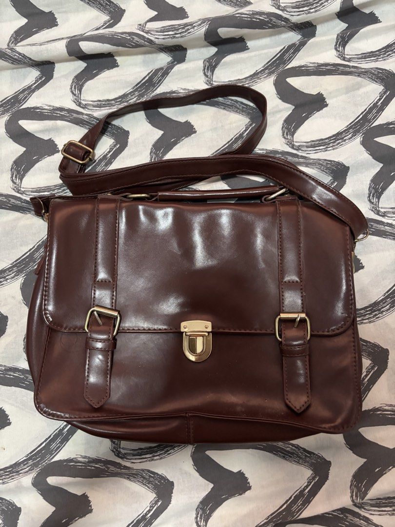 Y2k brown messenger / Satchel bags (Category: Shoulder Bags) located in Binan City. Submitted by eenvy_ (Listing ID 1461596491, Image 1). Description: Brown Messenger bag Semi small and sturdy Satin finish and gold buckles Mop: gcash Mod: jnt Dm for more details.