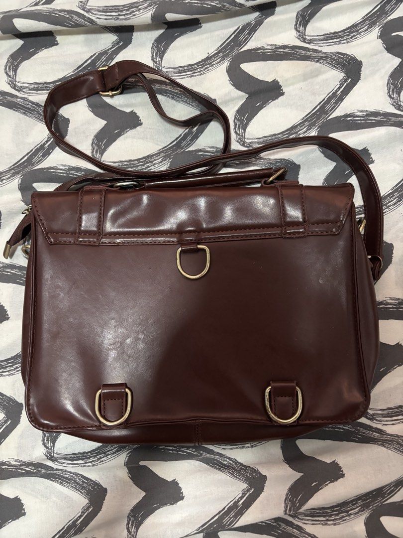 Y2k brown messenger / Satchel bags (Category: Shoulder Bags) located in Binan City. Submitted by eenvy_ (Listing ID 1461596491, Image 3). Description: Brown Messenger bag Semi small and sturdy Satin finish and gold buckles Mop: gcash Mod: jnt Dm for more details.