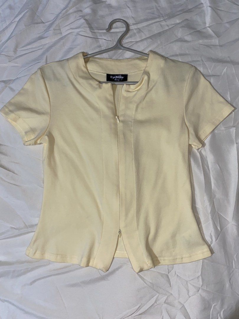 Yellow zippered top (Category: Blouses) located in Muntinlupa City. Submitted by leena3062 (Listing ID 1461703224, Image 1). Description: Decluterring ☺️ - Yellow short sleeve top from Riya Fashion - Features a zip detail at the front - Split hem design - Versatile for casual wear or dressing up.