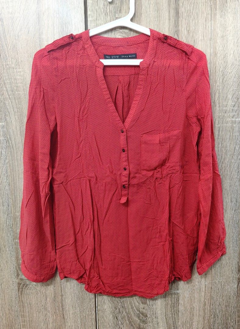 Zara Basic Red Polka Dot Long Sleeve Blouse XS (Category: Blouses) located in Las Pinas. Submitted by offtonewhome (Listing ID 1461566982, Image 1). Description: - Red Zara basic blouse with classic black polka dots. - Features a flattering V-neck with a full button-up front. - Long sleeves with button detail at the cuff. - Convenient small pocket on the left chest. - Please note: a faint dark mark is present on the front, near the pocket (refer 