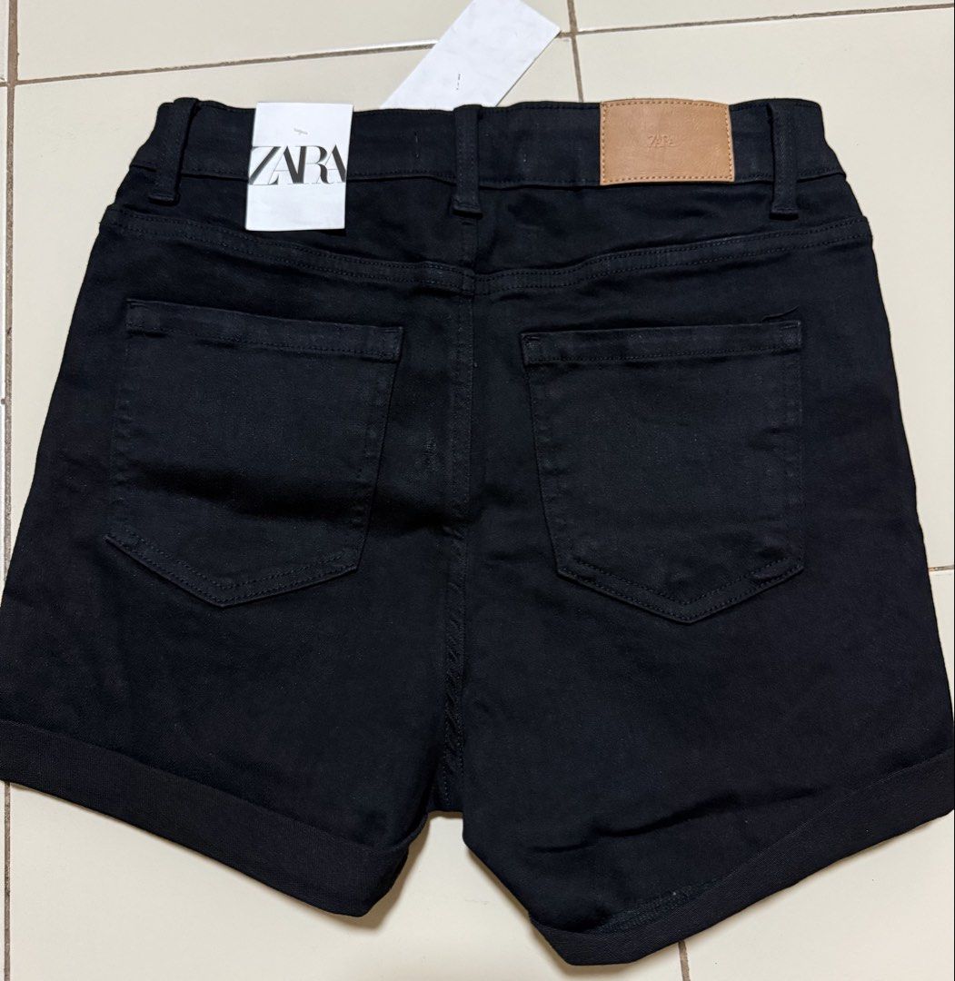 Zara Black Ripped Denim Shorts (Category: Shorts) located in Angeles City. Submitted by thon-thal (Listing ID 1461563959, Image 2). Description: - Brand: Zara - Style: Black denim shorts - Features: High-waisted, ripped details, cuffed hems - Occasion: Perfect for casual wear - Size: EUR 38 / US 06 / MEX 28 - Origin: Made in Bangladesh -size 28 stretchable.