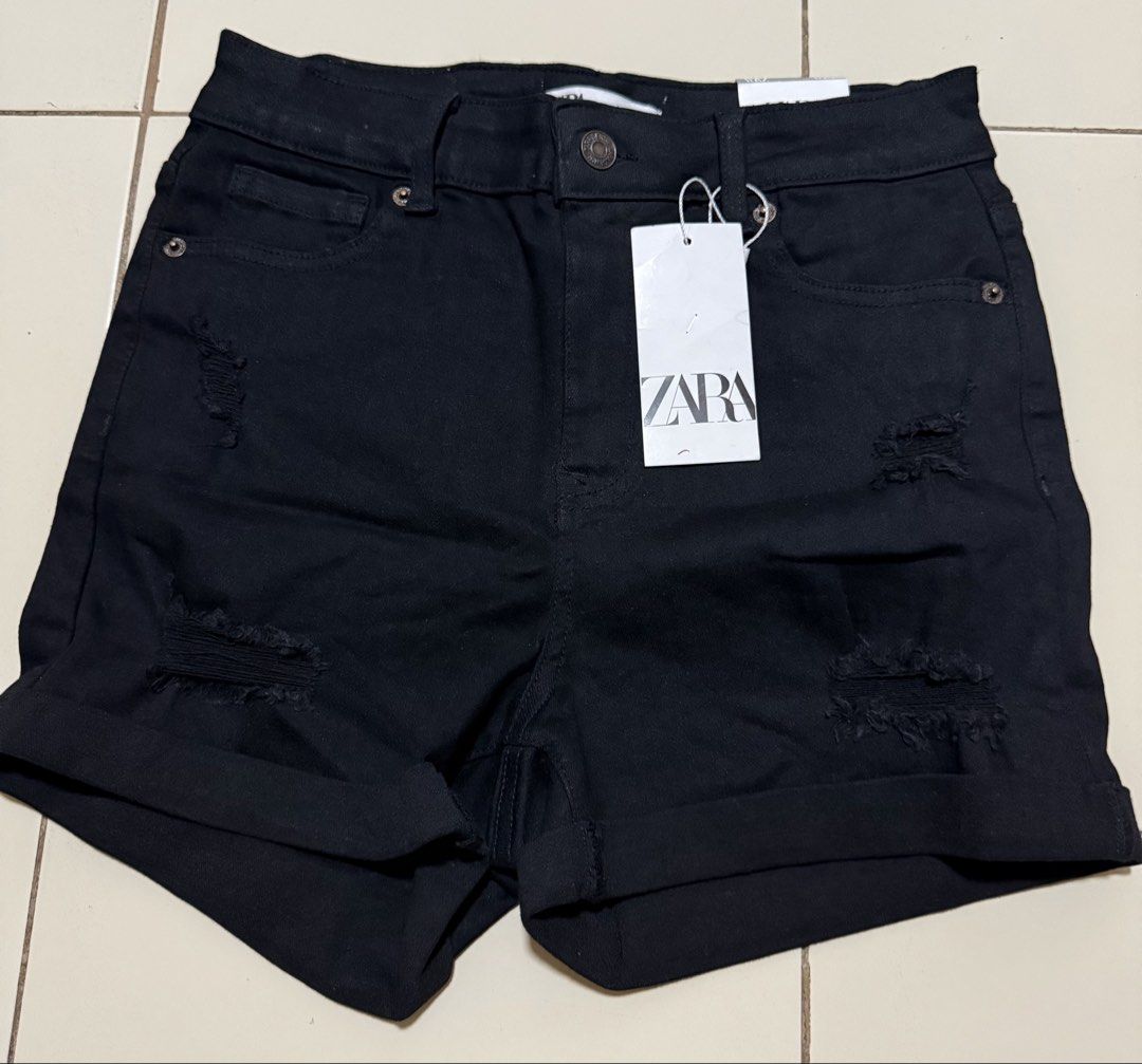 Zara Black Ripped Denim Shorts (Category: Shorts) located in Angeles City. Submitted by thon-thal (Listing ID 1461563959, Image 1). Description: - Brand: Zara - Style: Black denim shorts - Features: High-waisted, ripped details, cuffed hems - Occasion: Perfect for casual wear - Size: EUR 38 / US 06 / MEX 28 - Origin: Made in Bangladesh -size 28 stretchable.