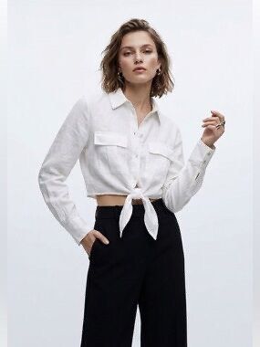 Zara Linen Cropped Bottonup (Category: Longsleeves) located in Manila. Submitted by closetbykiks (Listing ID 1461746362, Image 1). Description: Brand: Zara Size: Extra Small (EUR XS / USA XS / MEX 24) Color: White Material: Lightweight linen / linen-blend fabric Style: Long sleeve button-down cropped shirt featuring a front knot/tie detail, classic collar, long sleeves with button cuffs, and dual front flap chest pockets. Details: Features shell-