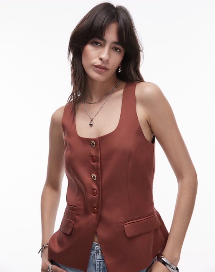 Zara Square Neck Button Front Vest Rust Orange (Category: Sleeveless) located in Manila. Submitted by ktyyycloset (Listing ID 1461740637, Image 2). Description: - Rust orange vest from Zara - Features a stylish square neckline - Button-front closure - Two functional flap pockets at the hem - Versatile piece for layering or standalone wear.