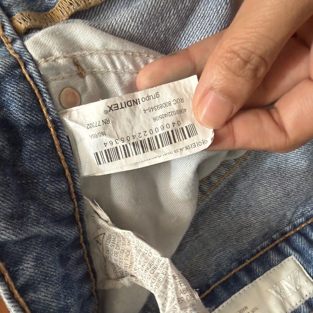 ZARA Wide Leg Ripped Jeans (Category: Jeans) located in Paranaque City. Submitted by prelovedbyelise_ (Listing ID 1461563868, Image 3). Description: - Brand: ZARA - Style: Light wash denim jeans - Fit: Wide leg silhouette - Details: Distressed rips on knees - Closure: Button and zip - Origin: Made in Pakistan - Size: EUR 36 / USA 4 / MEX 28 - Occasion: Great for a casual look.