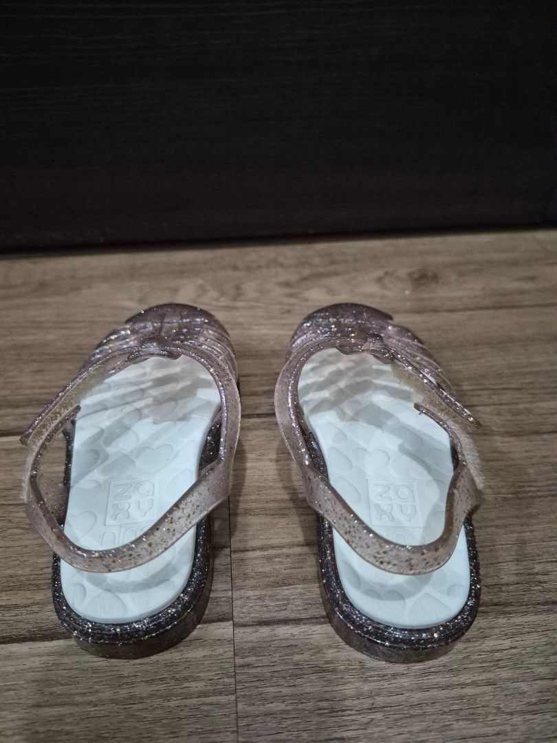 Zaxy Glitter Jelly Sandals (Category: Babies & Kids Fashion) located in Makati City. Submitted by mckie (Listing ID 1461564454, Image 2). Description: - Cute glitter jelly sandals for little ones - Clear with sparkly rose gold glitter - Easy slip-on and off design - Fun heart pattern on the soles - Ideal for beach days and outdoor play - Comfortable and durable for active kids - Perfect for summer adventures - US 7, EU 22.