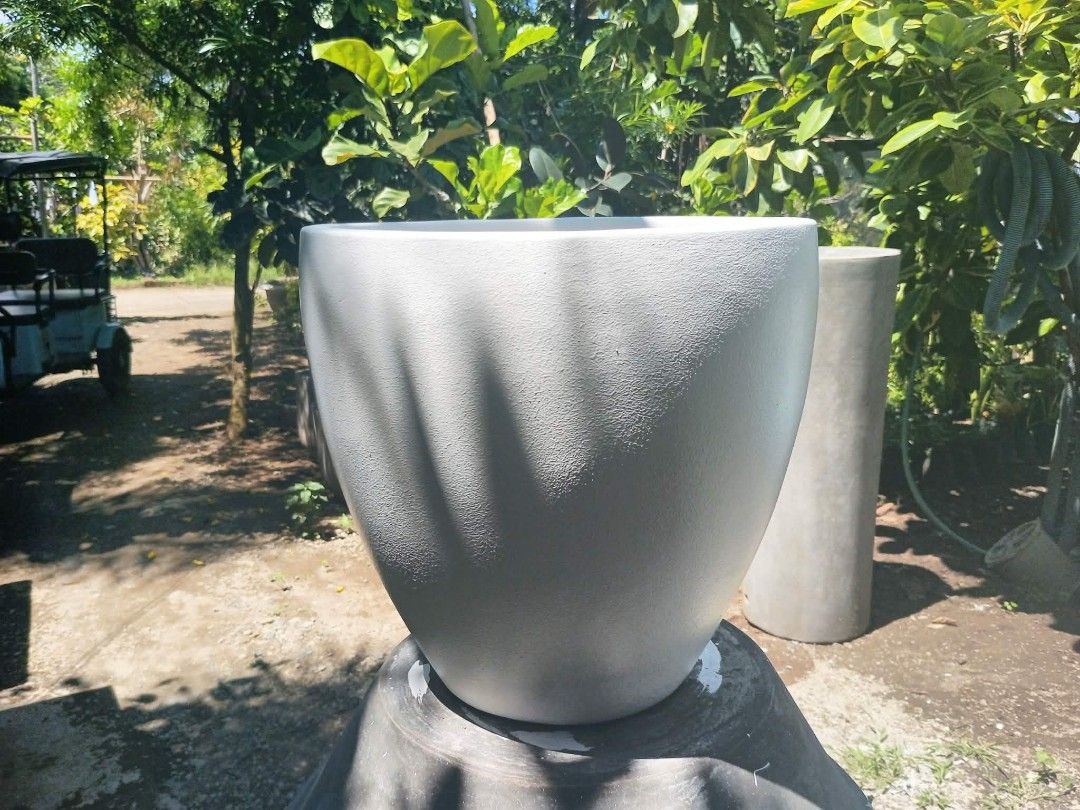 15x15 White Concrete Egg-Shaped Planter Pot (Category: Pots & Planters) located in Manila. Submitted by lorioalexi45697 (Listing ID 1461918820, Image 1). Description: - 15x15 concrete white planter pot - Unique egg shape - With wire inside. mas matibay pa sa ceramic or clay pot. - Textured finish for added style - Ideal for indoor/outdoor plants - Ready to give your plants a beautiful new home.