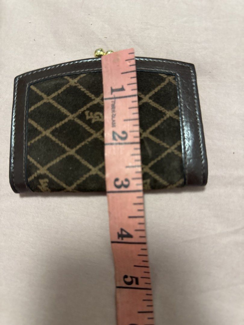 2027 Brown Monogram Coin Purse with Clasp (Category: Wallets & Card holders) located in Silang. Submitted by sari2bilina (Listing ID 1461841444, Image 1). Description: - Brown coin purse with diamond pattern - Leather trim for a touch of elegance - Secure gold clasp closure - Dark brown interior for a classic look - Compact size: approximately 4 inches wide - Ideal for organizing coins or small essentials.