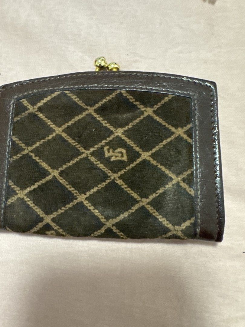 2027 Brown Monogram Coin Purse with Clasp (Category: Wallets & Card holders) located in Silang. Submitted by sari2bilina (Listing ID 1461841444, Image 3). Description: - Brown coin purse with diamond pattern - Leather trim for a touch of elegance - Secure gold clasp closure - Dark brown interior for a classic look - Compact size: approximately 4 inches wide - Ideal for organizing coins or small essentials.
