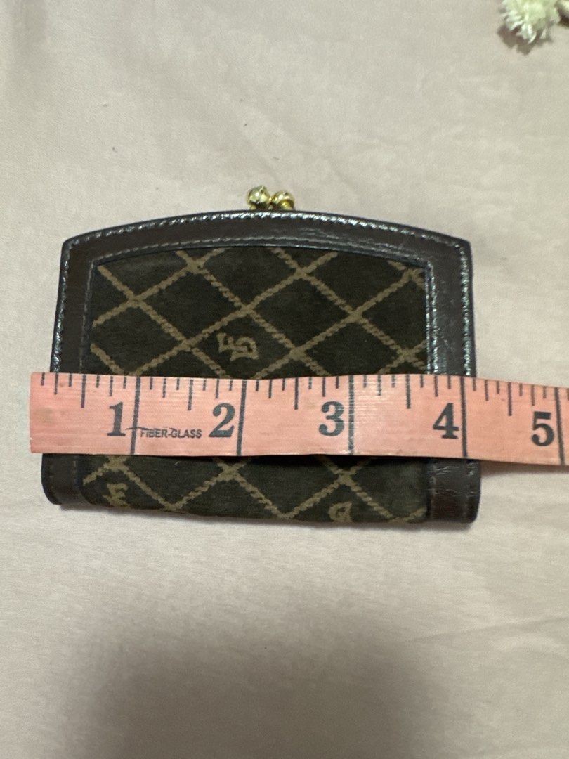 2027 Brown Monogram Coin Purse with Clasp (Category: Wallets & Card holders) located in Silang. Submitted by sari2bilina (Listing ID 1461841444, Image 2). Description: - Brown coin purse with diamond pattern - Leather trim for a touch of elegance - Secure gold clasp closure - Dark brown interior for a classic look - Compact size: approximately 4 inches wide - Ideal for organizing coins or small essentials.