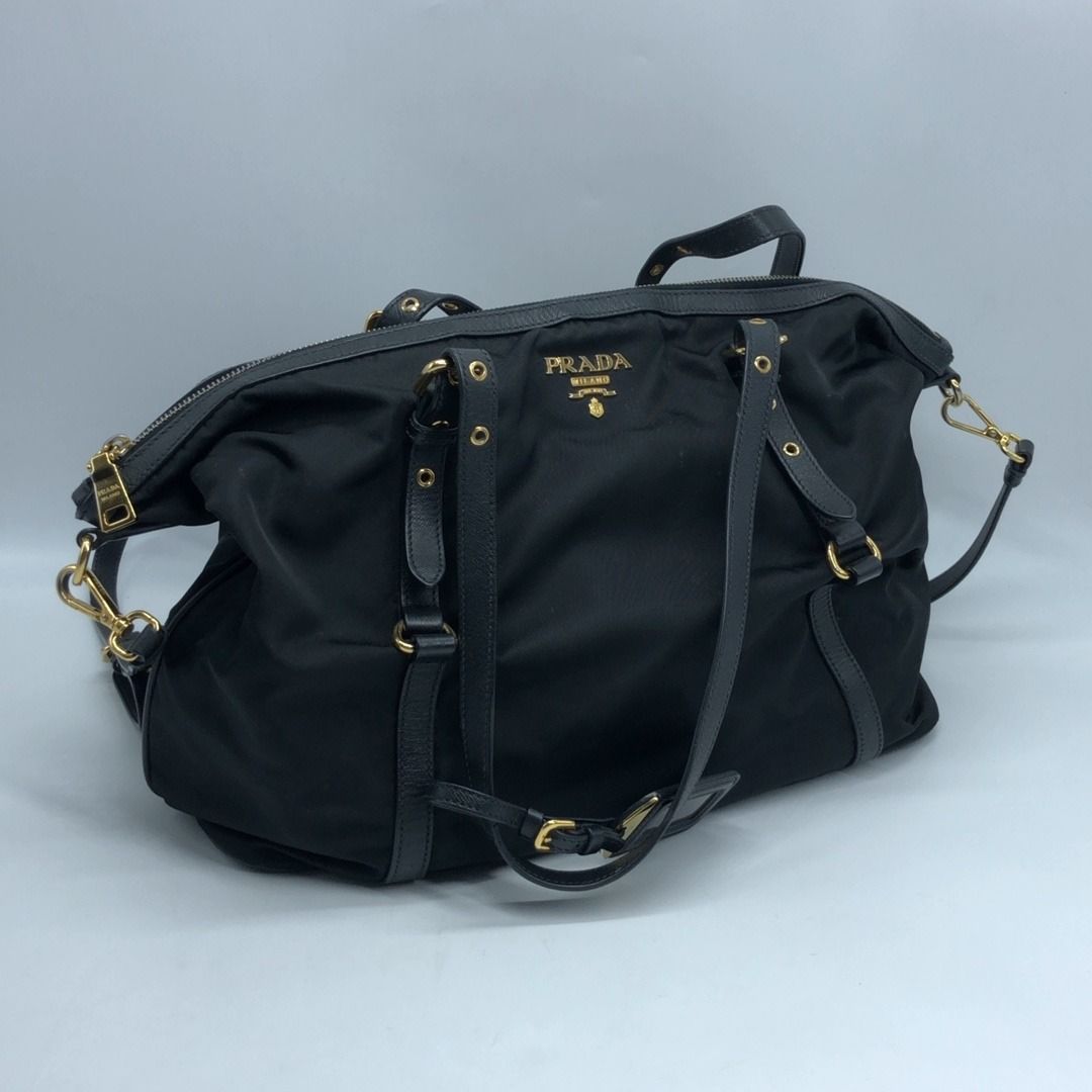 267008775 PRADA BAG NYLON 2 WAY BLACK BR4253 (Category: Luxury Bags & Wallets) located in Taguig. Submitted by ecoring.ph (Listing ID 1461823520, Image 1). Description: ◆CONDITION: B ◆DESCRIPTIONS: (Other defects/info:) OUTER: The body of the bag is stained, dirty, and shows signs of use. The bottom of the bag is also stained, dirty, and shows signs of use. The leather lining of the bag is scratched, scuffed, stained, dirty, wrinkled, has press m