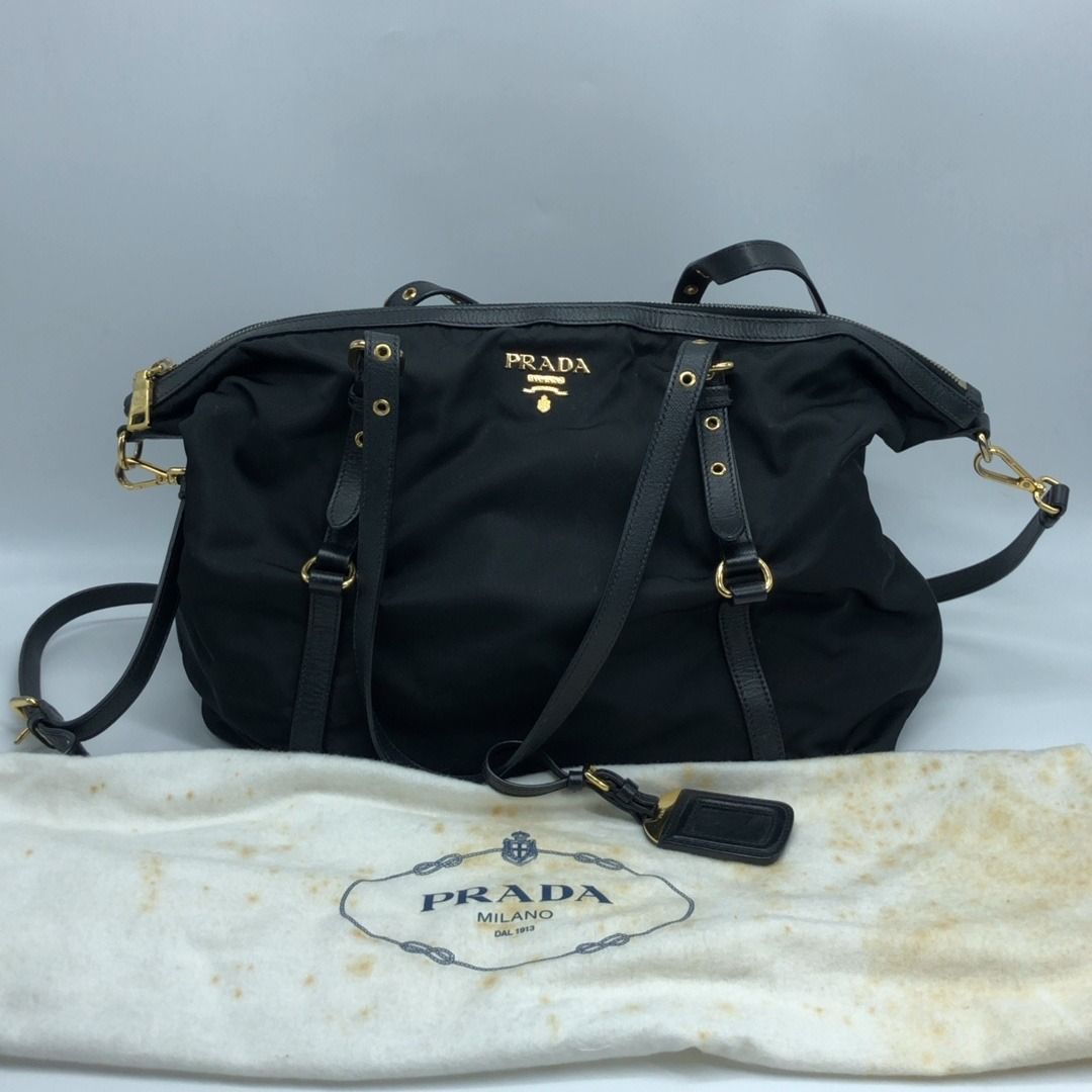 267008775 PRADA BAG NYLON 2 WAY BLACK BR4253 (Category: Luxury Bags & Wallets) located in Taguig. Submitted by ecoring.ph (Listing ID 1461823520, Image 2). Description: ◆CONDITION: B ◆DESCRIPTIONS: (Other defects/info:) OUTER: The body of the bag is stained, dirty, and shows signs of use. The bottom of the bag is also stained, dirty, and shows signs of use. The leather lining of the bag is scratched, scuffed, stained, dirty, wrinkled, has press m