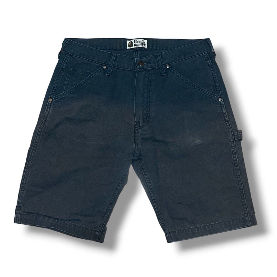 A Bathing Ape BAPE Carpenter Shorts (Category: Shorts) located in Manila. Submitted by jstash09 (Listing ID 1461955819, Image 1). Description: - Dark grey BAPE carpenter shorts - Classic BAPE logo tag on front waistband - Small logo patch on back pocket - Utility style with hammer loop on the side - Size S - Great for casual wear -Fits 30-32 x 20” .
