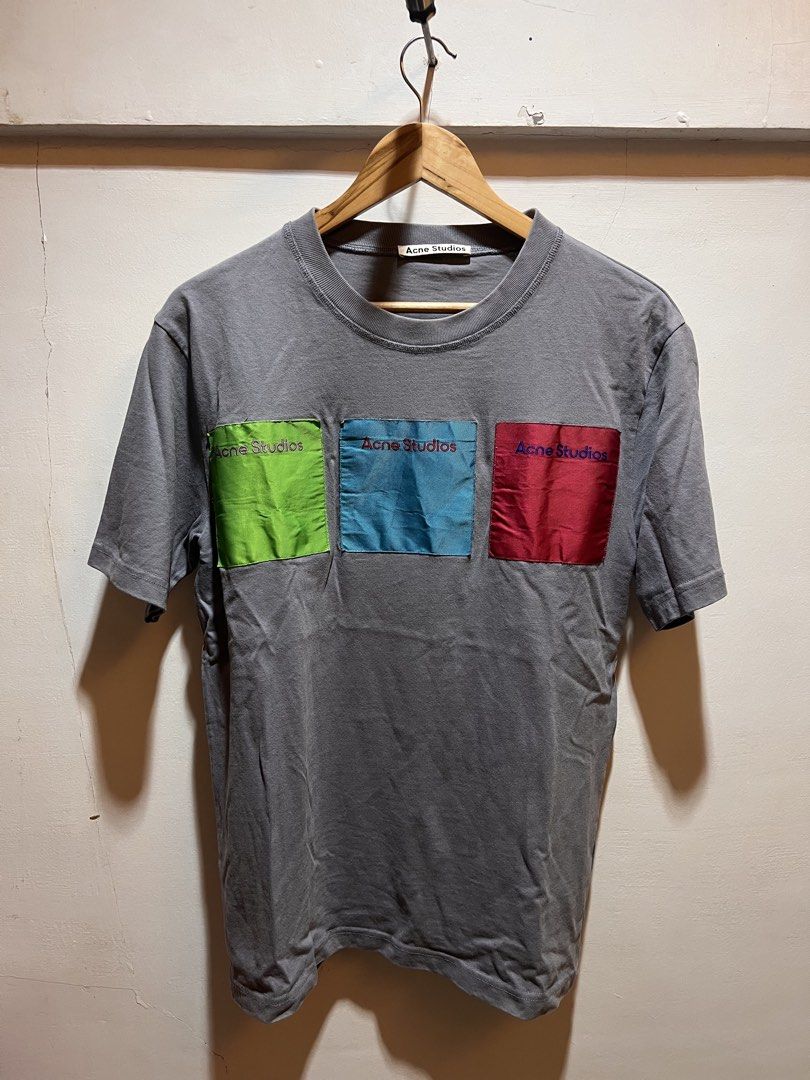 Acne Studios Grey T-shirt with Colour Block Pockets (Category: Tshirts & Polo Shirts ) located in San Juan, La Union. Submitted by jeggystyle (Listing ID 1461963344, Image 1). Description: - Grey Acne Studios t-shirt - Features three small, colorful pockets on the front (green, blue, red) - Short sleeves and crew neck design - Simple, stylish, and ideal for casual wear Fits large.