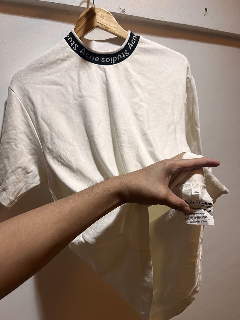 Acne Studios White T-shirt with Logo Neckline (Category: Tshirts & Polo Shirts ) located in San Juan, La Union. Submitted by jeggystyle (Listing ID 1461963547, Image 2). Description: - Authentic Acne Studios white t-shirt - Features signature brand name on the neckline - Classic short sleeves - Designed for a comfortable, relaxed fit - Ideal for everyday casual wear Fits large.
