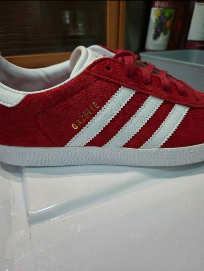 Adidas Gazelle Red Suede Sneakers (Category: Sneakers) located in Manila. Submitted by hello.chinggu (Listing ID 1461908850, Image 3). Description: - Classic Adidas Gazelle sneakers - Vibrant red suede material - Iconic three stripes design - Gold 'Gazelle' lettering detail - White sole and laces - Features OrthoLite sockliner for enhanced comfort - Ideal for casual wear and everyday styling used only once as it is the wrong size for me.