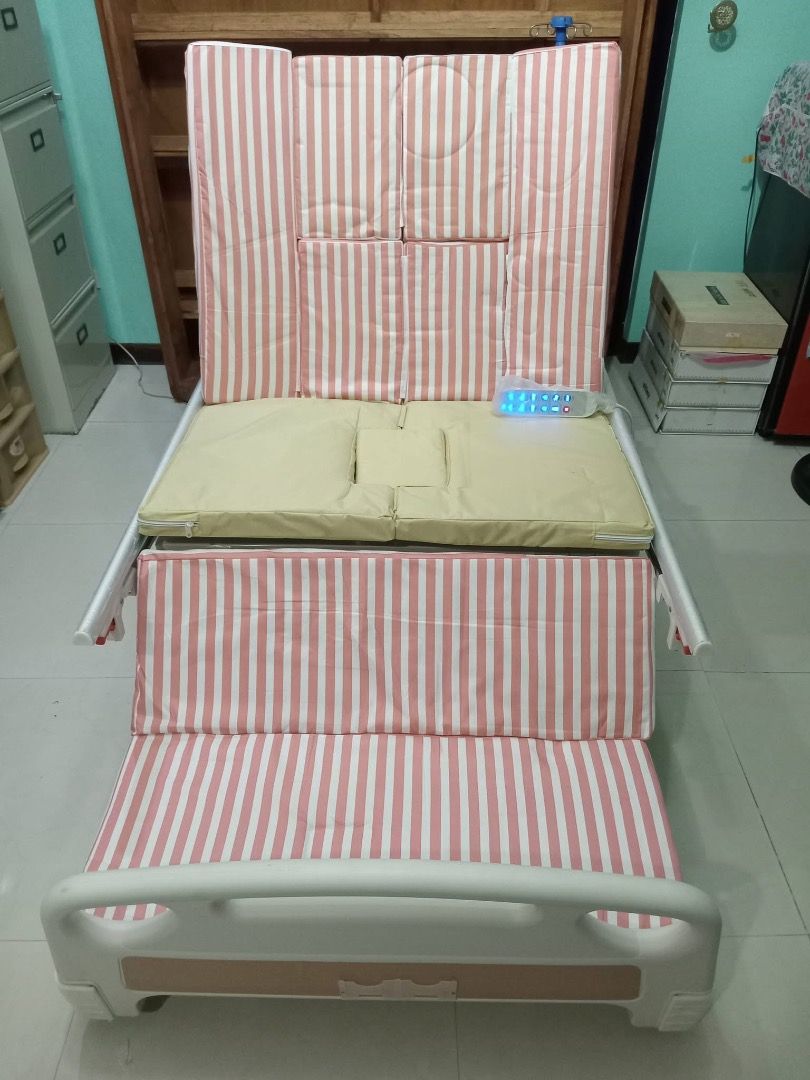Adjustable Electric Hospital Bed with Remote Control (Category: Bed Frames & Mattresses) located in Las Pinas. Submitted by quickfalcon.244d07 (Listing ID 1461978136, Image 2). Description: - Fully functional electric hospital bed - Multiple adjustable positions (backrest & leg rest) - Easy operation with remote control - Built-in bedpan opening - Pink and white striped mattress cover - Perfect for home care needs.
