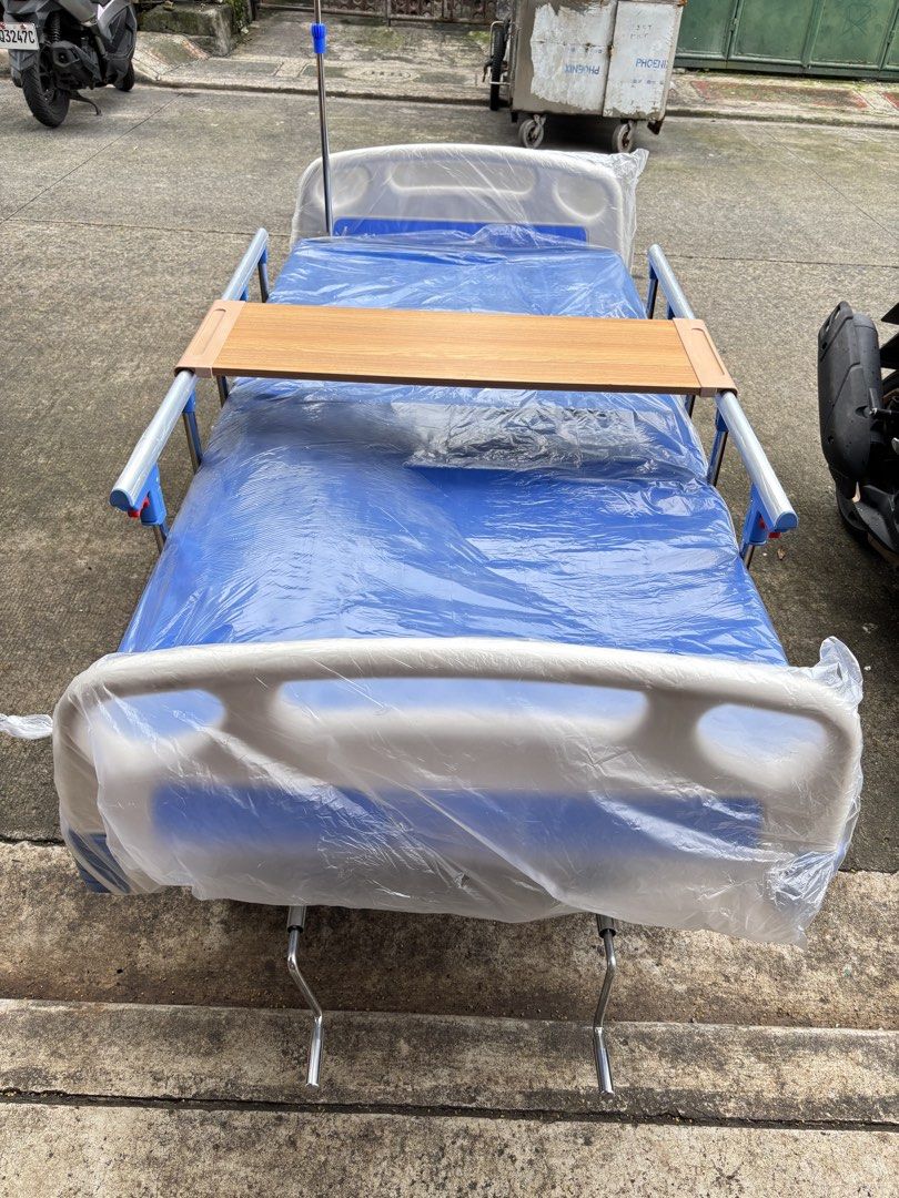 Adjustable Hospital Bed with Wheels and Tray (Category: Medical Supplies & Tools) located in Manila. Submitted by rosel2001 (Listing ID 1461833512, Image 1). Description: - Adjustable hospital bed - Includes side tray - Equipped with wheels for easy mobility - Safety side rails for added security - IV pole attachment point - Mattress covered in blue plastic - Ready for immediate use.