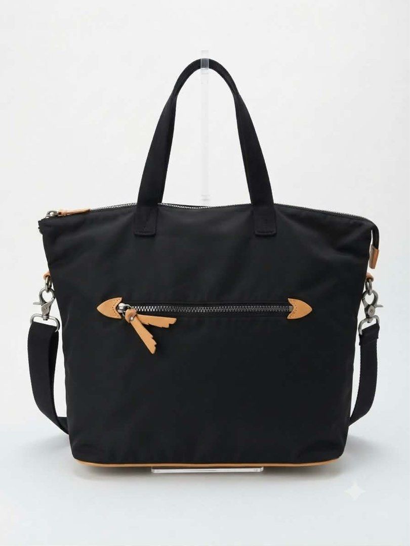 AIGLE Black Nylon Tote Bag with Shoulder Strap (Category: Tote Bags) located in Cavite. Submitted by bags_unltd143 (Listing ID 1461840538, Image 2). Description: - Brand: AIGLE - Material: Durable Nylon - Color: Black - Features: Top handles, detachable shoulder strap - Exterior: Zippered front pocket with leather accents - Interior: Zippered pocket, small open pocket - Ideal for: Everyday use, practical and durable.