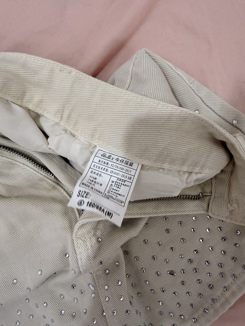 AIMEE Embellished Denim Mini Skirt (Category: Skirts) located in Tuguegarao City. Submitted by joysmithznjo (Listing ID 1461941692, Image 3). Description: - Cream denim mini skirt from AIMEE - Features all-over rhinestone embellishments on the hem - Classic five-pocket design - Zipper and button closure - Size: 160/68A (Medium) - Made in China - Perfect for versatile styling, dress up or down.