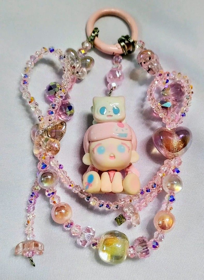All authentic (price per each) (Category: Handmade Craft) located in Caloocan City. Submitted by jark_moonshop (Listing ID 1461906403, Image 2). Description: 250 pesos each can do lalamove or JNT - Handmade beaded keychain charm - Features a cute figurine - Comes with a cat or bow accessory - Available in purple, pink, brown, and yellow themes - Perfect for decorating bags or keys - A unique and charming accessory.