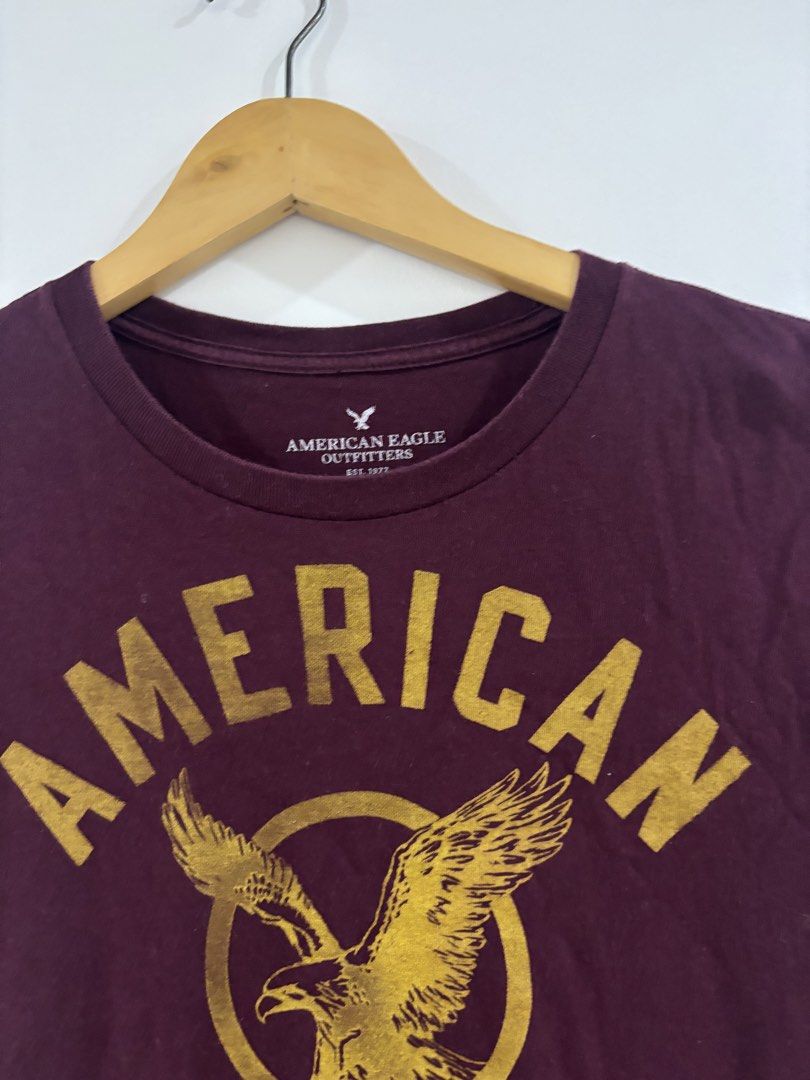 American Eagle Graphic Tee (Category: Tshirts & Polo Shirts ) located in Bulacan. Submitted by janeeeeelleeeee (Listing ID 1462002481, Image 2). Description: - Burgundy t-shirt from American Eagle Outfitters - Features a gold eagle graphic with brand name - Short sleeves, crew neck - Comfortable cotton blend - Perfect for casual wear - S-M.