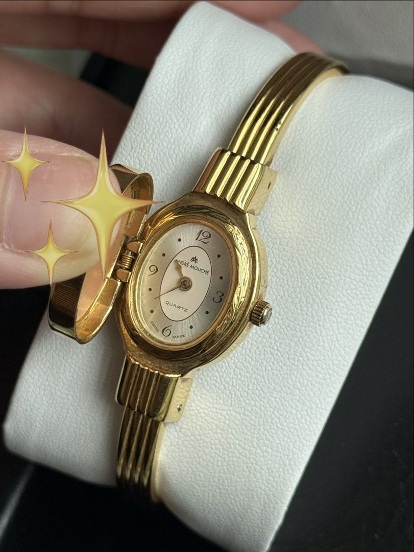 Andre Mouche Quartz Cameo Bangle Watch Swiss Made (Category: Women's Watches) located in Manila. Submitted by beaalipon (Listing ID 1461819480, Image 2). Description: - Mother of Pearl face - Beautiful gold-tone watch - Features a classic cameo face - Reliable Swiss Made quartz movement - 14-16cm Location: BGC.