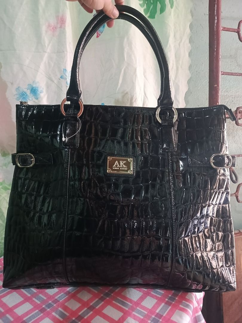 Anne Klein Black Croc Embossed Tote Bag (Category: Tote Bags) located in Caloocan City. Submitted by janeeh_007 (Listing ID 1461871380, Image 1). Description: - Stylish black tote bag - Luxurious croc-embossed texture - Shiny patent finish - Interior features Anne Klein logo - Ample space for your essentials - Durable, sturdy handles - Ideal for everyday wear.