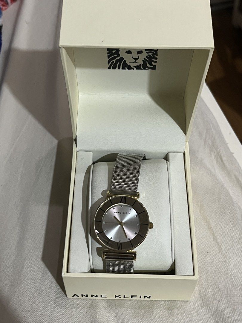 Anne Klein Women's Mesh Strap Watch (Category: Women's Watches) located in Manila. Submitted by mxinii (Listing ID 1461903557, Image 2). Description: - Brand: Anne Klein - Dial Color: Silver - Case Color: Gold-tone - Strap Type: Mesh - Dial Details: Roman numeral at 12 o'clock, small stone accents - Includes: Original box (has damage) - Style: Ideal for everyday wear.