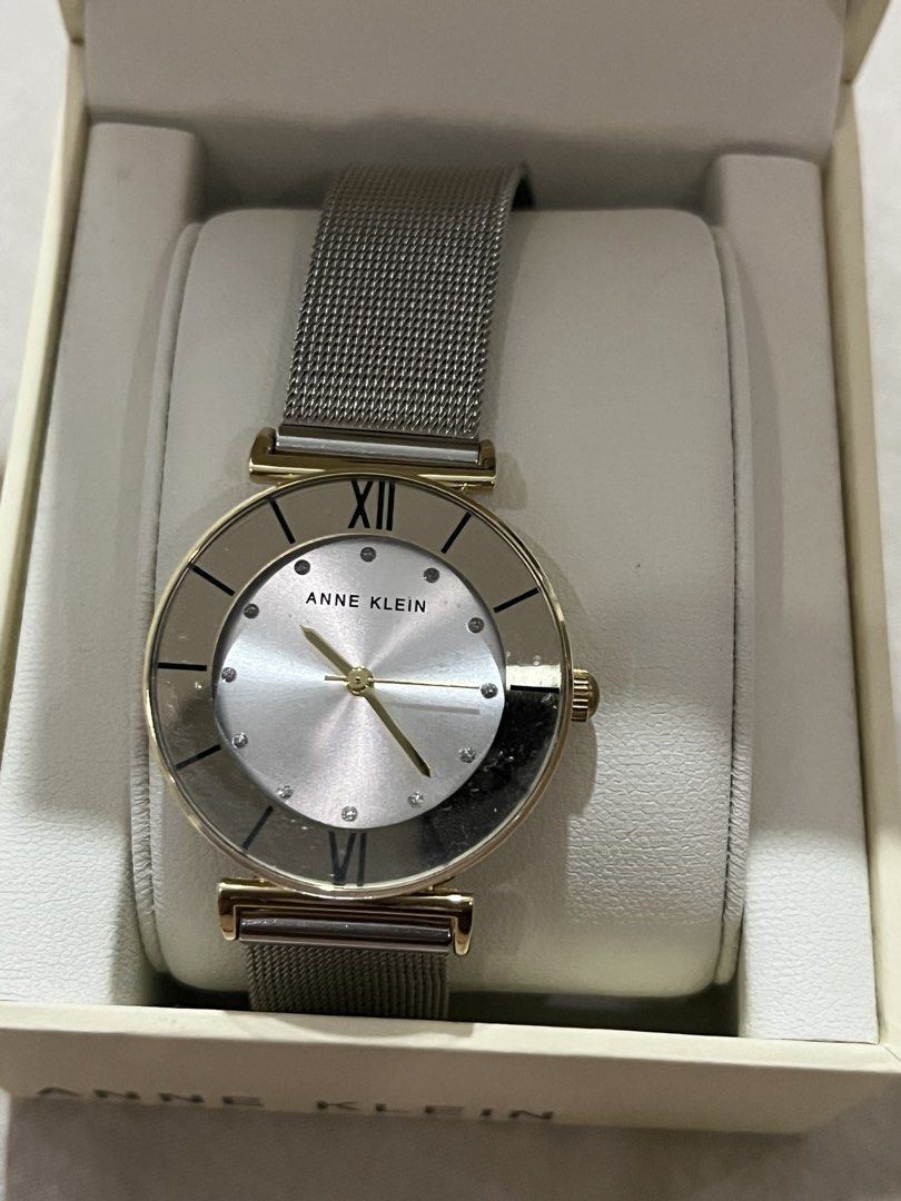 Anne Klein Women's Mesh Strap Watch (Category: Women's Watches) located in Manila. Submitted by mxinii (Listing ID 1461903557, Image 1). Description: - Brand: Anne Klein - Dial Color: Silver - Case Color: Gold-tone - Strap Type: Mesh - Dial Details: Roman numeral at 12 o'clock, small stone accents - Includes: Original box (has damage) - Style: Ideal for everyday wear.