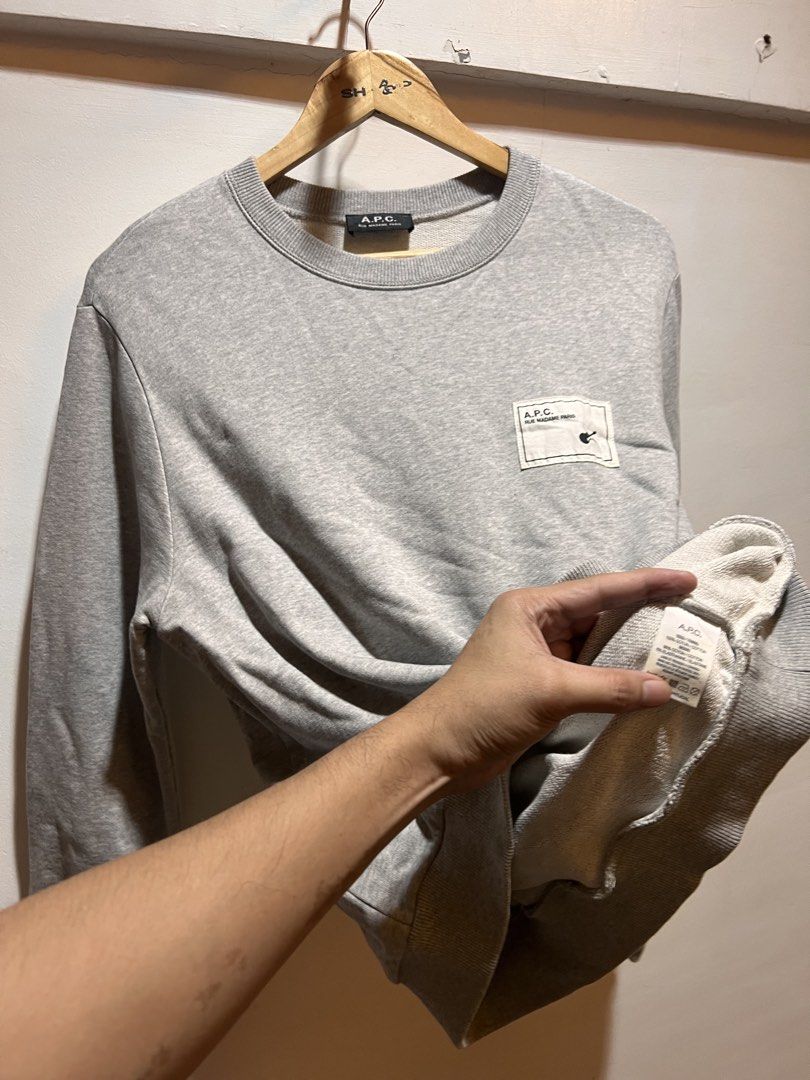 A.P.C. Grey Crewneck Sweatshirt (Category: Coats, Jackets and Outerwear) located in San Juan, La Union. Submitted by jeggystyle (Listing ID 1461963840, Image 2). Description: - Grey A.P.C. crewneck sweatshirt - Features a small graphic patch on the chest - Classic crewneck design - Ribbed cuffs and hem for a comfortable fit - Versatile for everyday wear and layering Fits large.