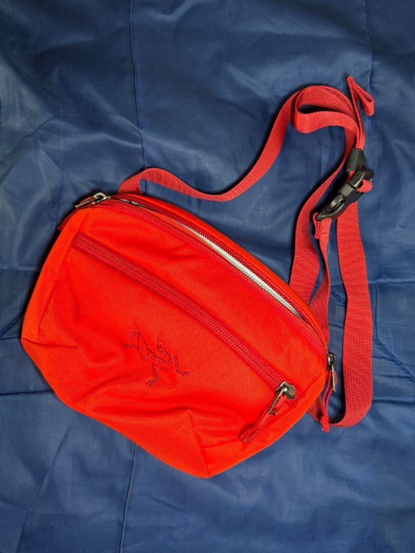 Arcteryx - Red Orange body bag (Mini) (Category: Belt bags, Clutches and Pouches) located in Las Pinas. Submitted by nproducts (Listing ID 1461936399, Image 1). Description: Type: Sling Bag Color: Red / Orange (Adjustable body strap) Bought from: Arcteryx Store - Toronto, Canada Classification: 100% Original item Condition: Good as new on the outside, few removable stains in the inside due to usage Reason for selling: Not using it anymore (Declut