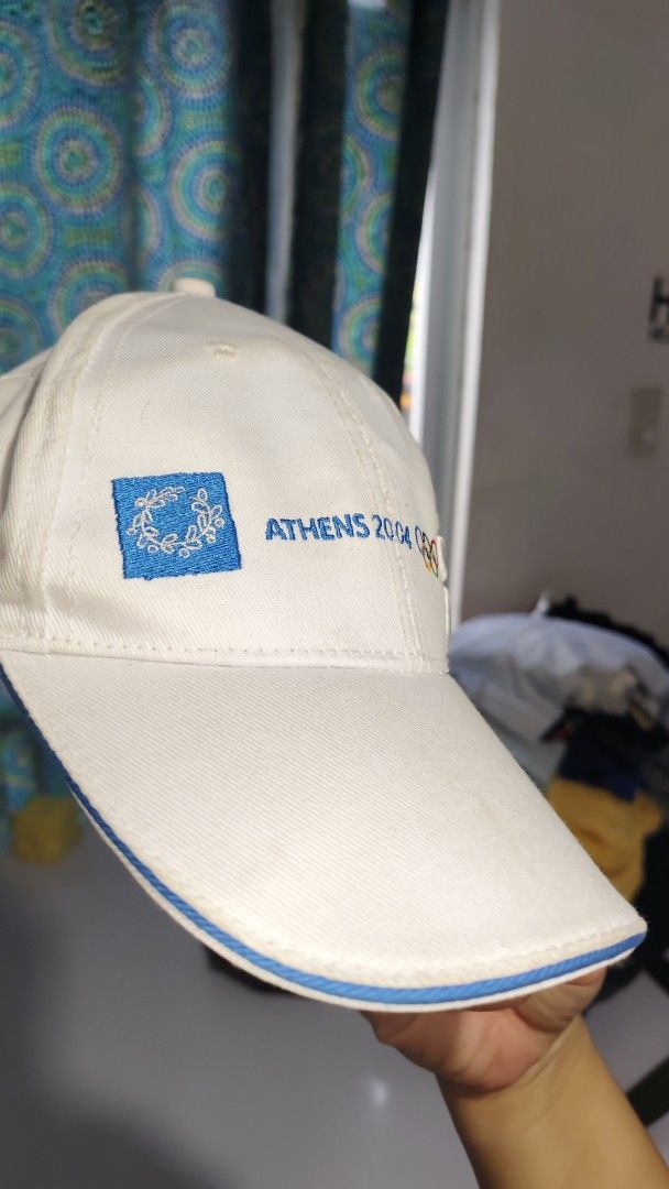 Athens 2004 Olympics White Baseball Cap (Category: Caps & Hats) located in Bulacan. Submitted by babz30261 (Listing ID 1461891677, Image 2). Description: - White cap from the Athens 2004 Olympics - Features embroidered details on the front and side - Blue trim along the brim and inside - Ideal souvenir for any Olympics fan - Show your support for the games.