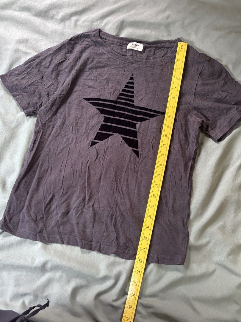 BEAMS T-shirt with Black Star Graphic (Category: Blouses) located in Andop. Submitted by ukaylangpo (Listing ID 1461853749, Image 3). Description: EXCELLENT CONDITION 17x22 - Brand: BEAMS - Color: Grey - Design: Bold black star graphic on front, small star details on back - Style: Short sleeves, classic crew neck - Condition: Comfortable everyday tee - Note: Measurements available upon request.